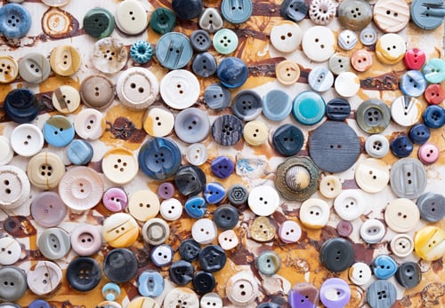 Preview: Group of retro colorful fashion clothing buttons on a board