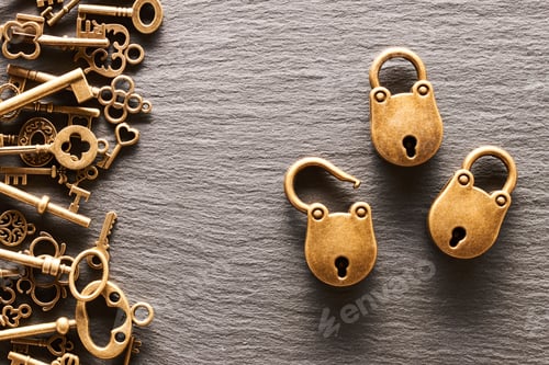 Preview: Various metal keys and locks on slate background