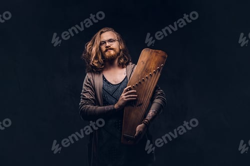 Preview: Redhead hipster male playing on a Russian traditional musical instrument - gusli
