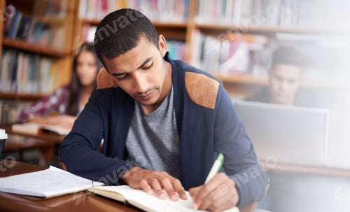 Preview: Working diligently. Cropped shot of a handsome young student working diligently in his classroom.