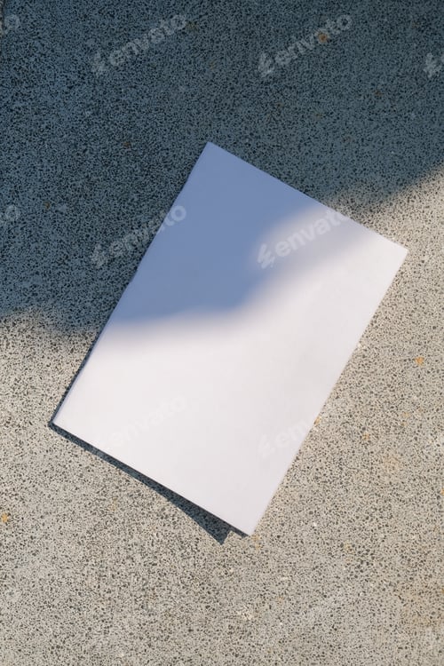 Preview: empty magazine mockup on concrete stone floor or pavement outdoors, shadow overlay
