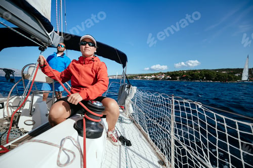 Preview: Attractive strong woman sailing with her boat
