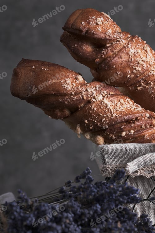 Preview: White bread in a basket and lavender flowers in vintage style.