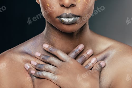 Preview: cropped view of african american woman with silver makeup pising for fashion shoot