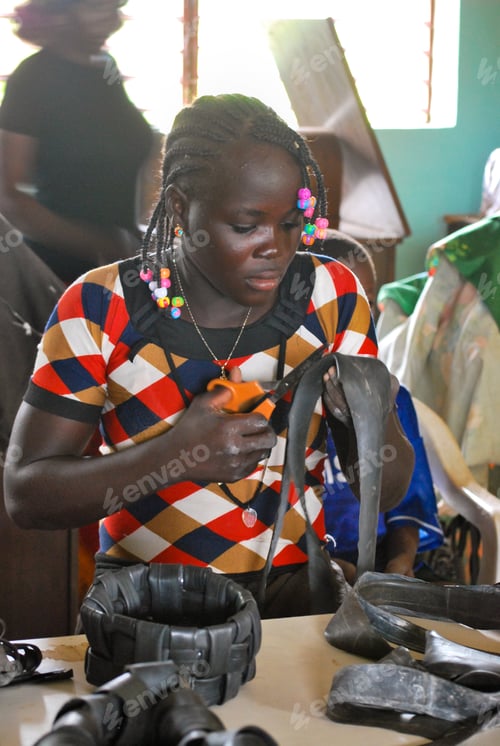 Preview: African youngsters making baskets out of bicycle tires during recycling activity in a social center