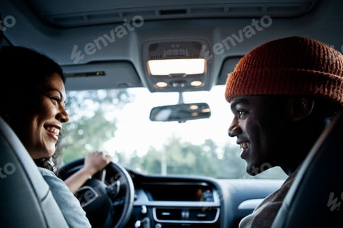 Preview: Young couple chatting in front seat of car