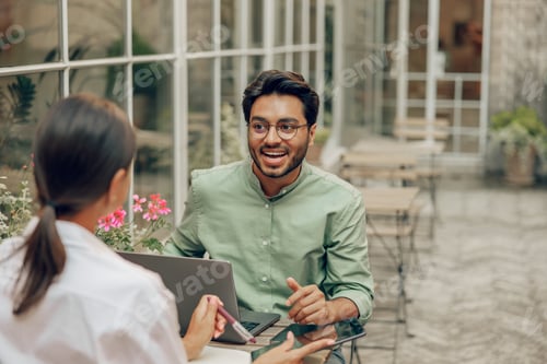 Preview: Business coworkers working on project while use laptop sitting in coworking terrace