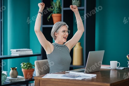 Preview: Shot of a businesswoman looking cheerful while using her laptop