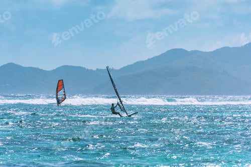 Preview: Two surfers on horizon on sunny day. Outdoor summer recreation on sea.