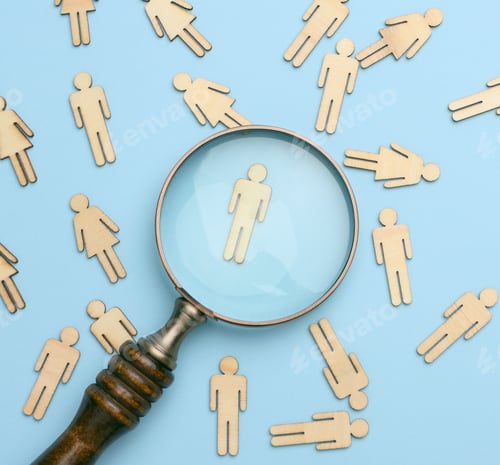 Preview: Wooden men and a magnifying glass on a blue background