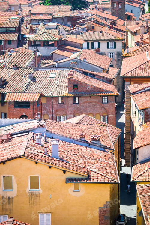 Preview: Beautiful view of ancient old buildings with red roofs background mountains in Lucca, Italy
