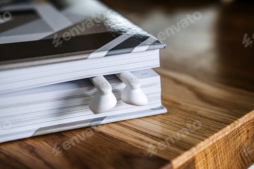 Preview: Earphones Tucked into a Book for Audiobook Concept