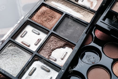 Preview: Different used eyeshadow palettes as background, closeup