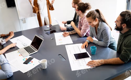 Preview: Working together on project. Happy young business colleagues working in office