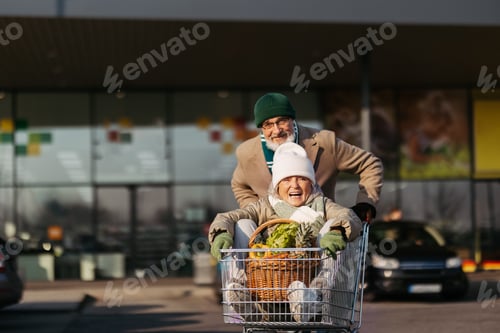 Preview: Senior couple going home from grocery store, having fun.