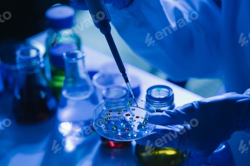 Preview: scientist analyzing and dropping a sample into a glassware.