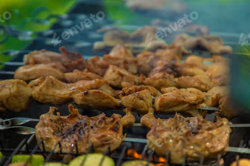 Preview: A man roasts meat over a fire. Selective focus.