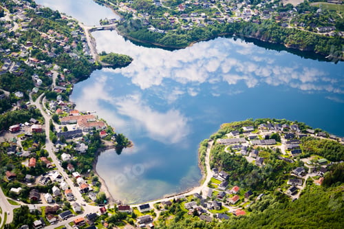 Preview: View of the picturesque Lofoten village in Norway, with the sky, mirrored in the waters below