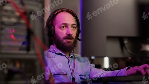 Preview: Handheld shot of gamer with headset streaming gameplay shouting after winning online multiplayer