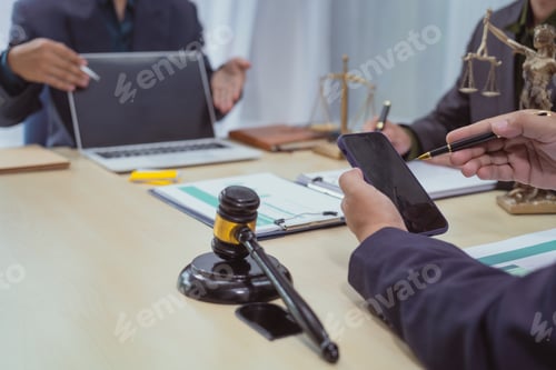 Preview: Three lawyers in a meeting at the table in an office, discussing business,civil and commercial law