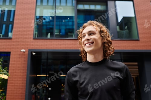 Preview: Sporty young man enjoys life outside a modern building filled with large windows