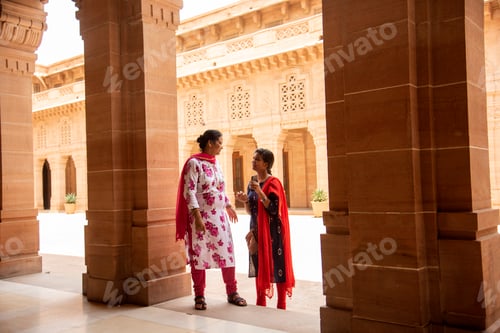 Preview: Indian woman standing between arches and Pillars.