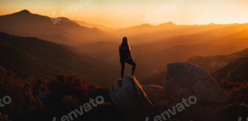 Preview: Woman faces a beautiful mountain sunset