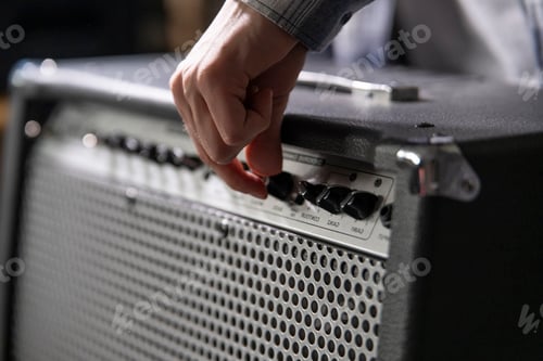 Preview: a Guitarist Fine-Tunes Amplifier Settings Before a Performance in a Backstage Area