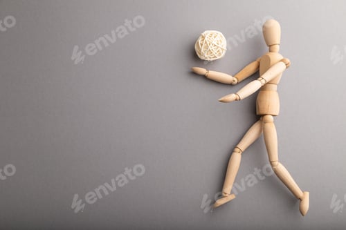 Preview: Wooden mannequin playing football on gray pastel background. copy space.