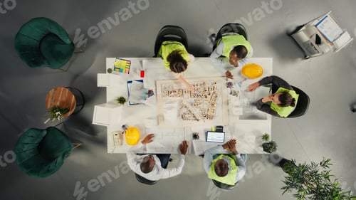 Preview: Top down view of development team consulting on real estate investment