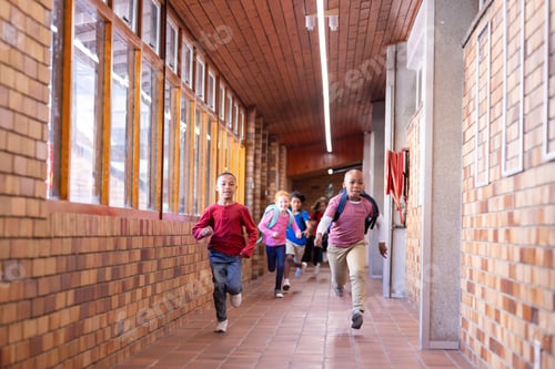 Preview: Running down school hallway, diverse children with backpacks enjoying recess time