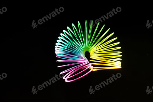 Preview: Closeup shot of a colorful slinky isolated on a black background