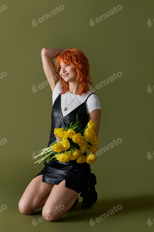 Preview: A young woman with vibrant red hair poses gracefully, showcasing trendy spring attire