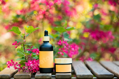 Preview: Cosmetic bottle and jar on wooden table in blooming tree spring garden