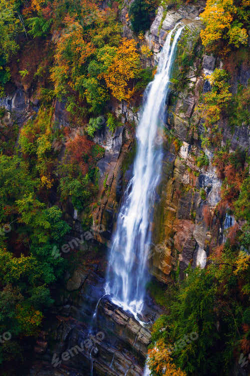 Preview: waterfall falling down the cliff in autumn