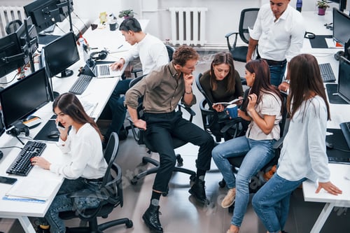 Preview: Young business people working together in the modern office