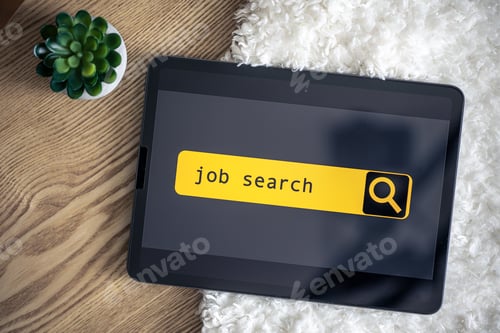 Preview: Top view of digital tablet with search job on screen on a table.