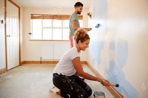 Preview: Couple Decorating Room In New Home Painting Wall Together