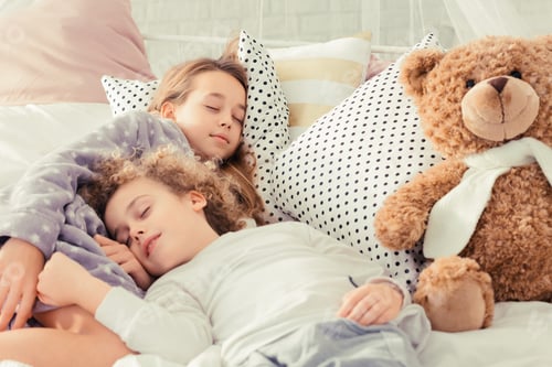 Preview: Siblings sleeping in bed