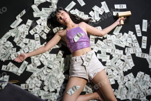 Preview: Died young asian woman surrounded by dollar bills. Suicide with a gunshot.