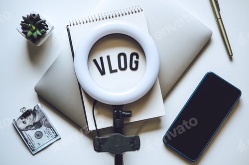Preview: How To Do Vlog. Word Vlog and Laptop, Mobile Phone, notebook and glasses on the table