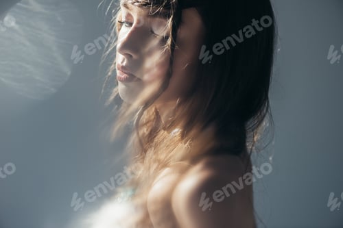 Preview: tender boho girl with braids in hairstyle posing on grey with lens flares
