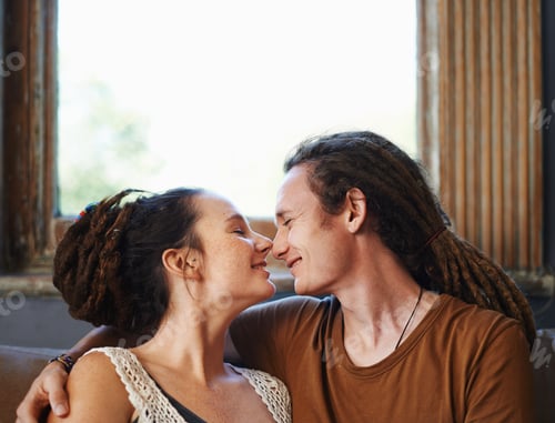 Preview: Dread-lock love. Shot of an affectionate dread-locked couple sitting at home.