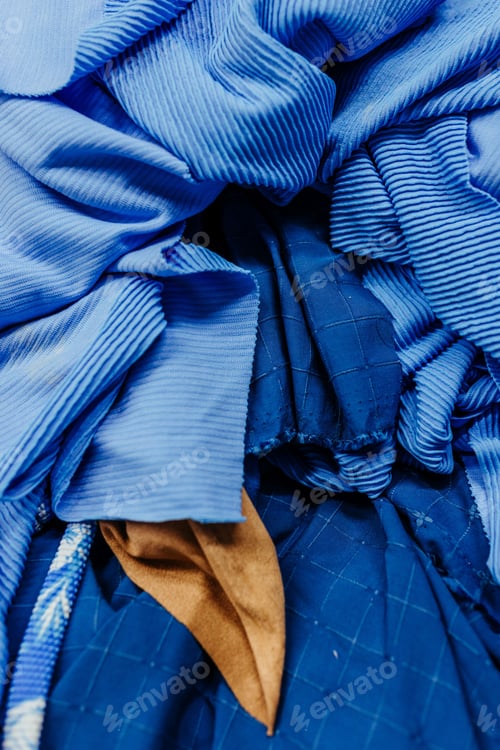 Preview: Closeup of soft blue fabric swatches background