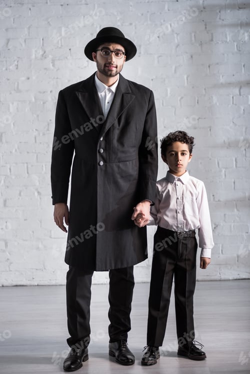 Preview: handsome jewish father and cute son holding hands