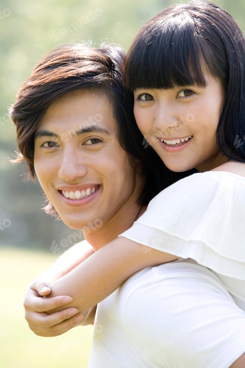 Preview: Young man carrying young woman on back
