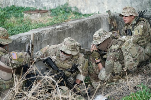 Preview: Soldier in full US MARSOC armed with assault rifle run through the abandoned building. Military