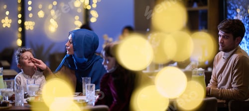 Preview: In a modern restaurant, an Islamic couple and their children joyfully await their iftar meal during