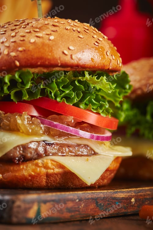 Preview: Appetizing homemade burger with beef, cheese and onion marmalade close-up.