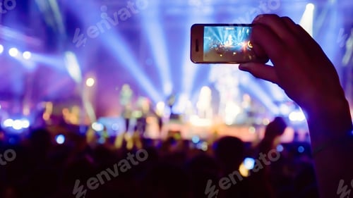 Preview: Fan taking photo of concert